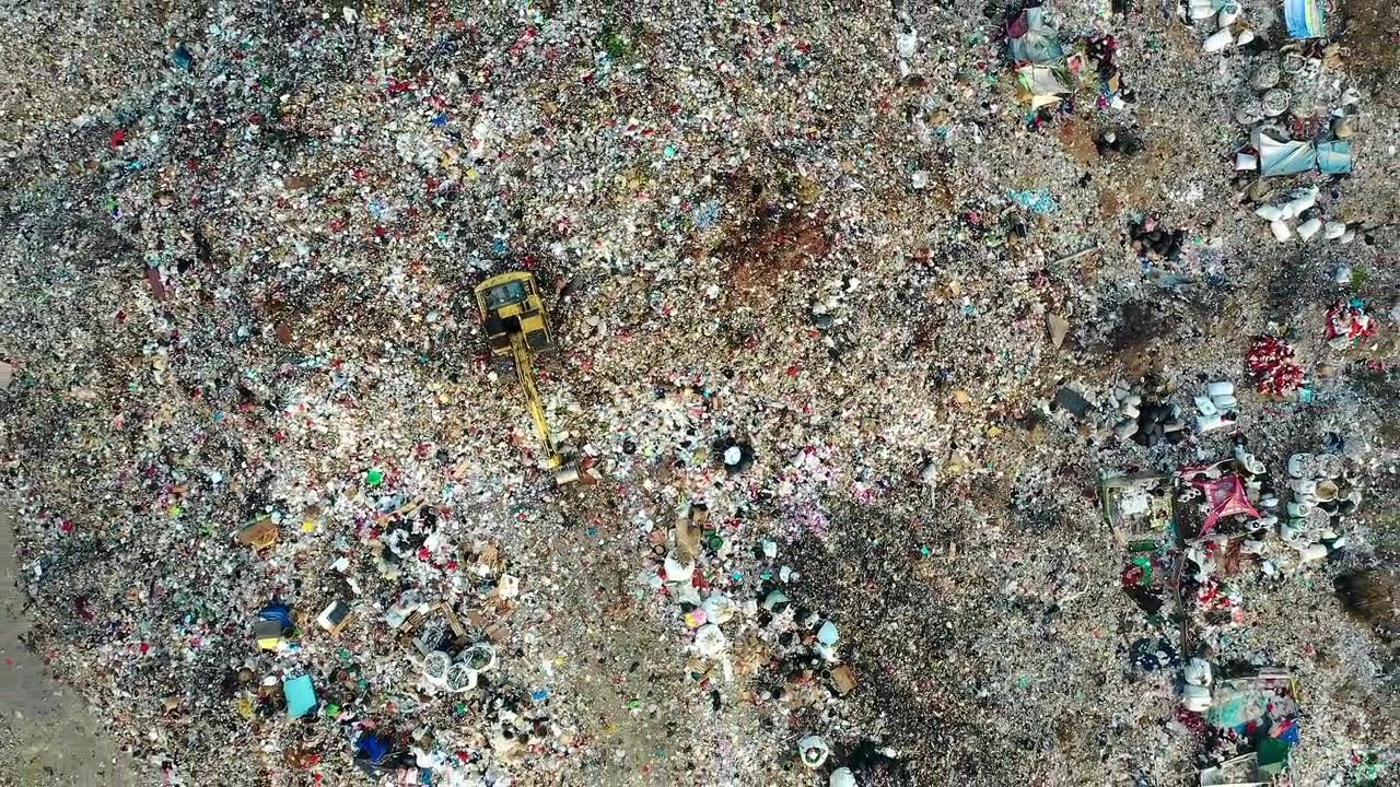 Aerial view of a landfill overflowing with plastic and mixed waste